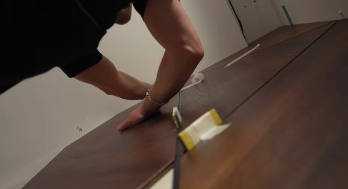 Construction crew installing reclaimed wood wall panels in LEED certified building renovation project