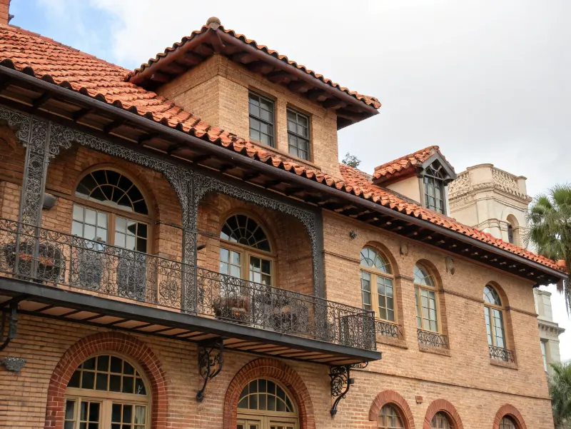 Historic Tampa building facade showing Spanish colonial terracotta tile roof wrought iron balcony and arched windows
